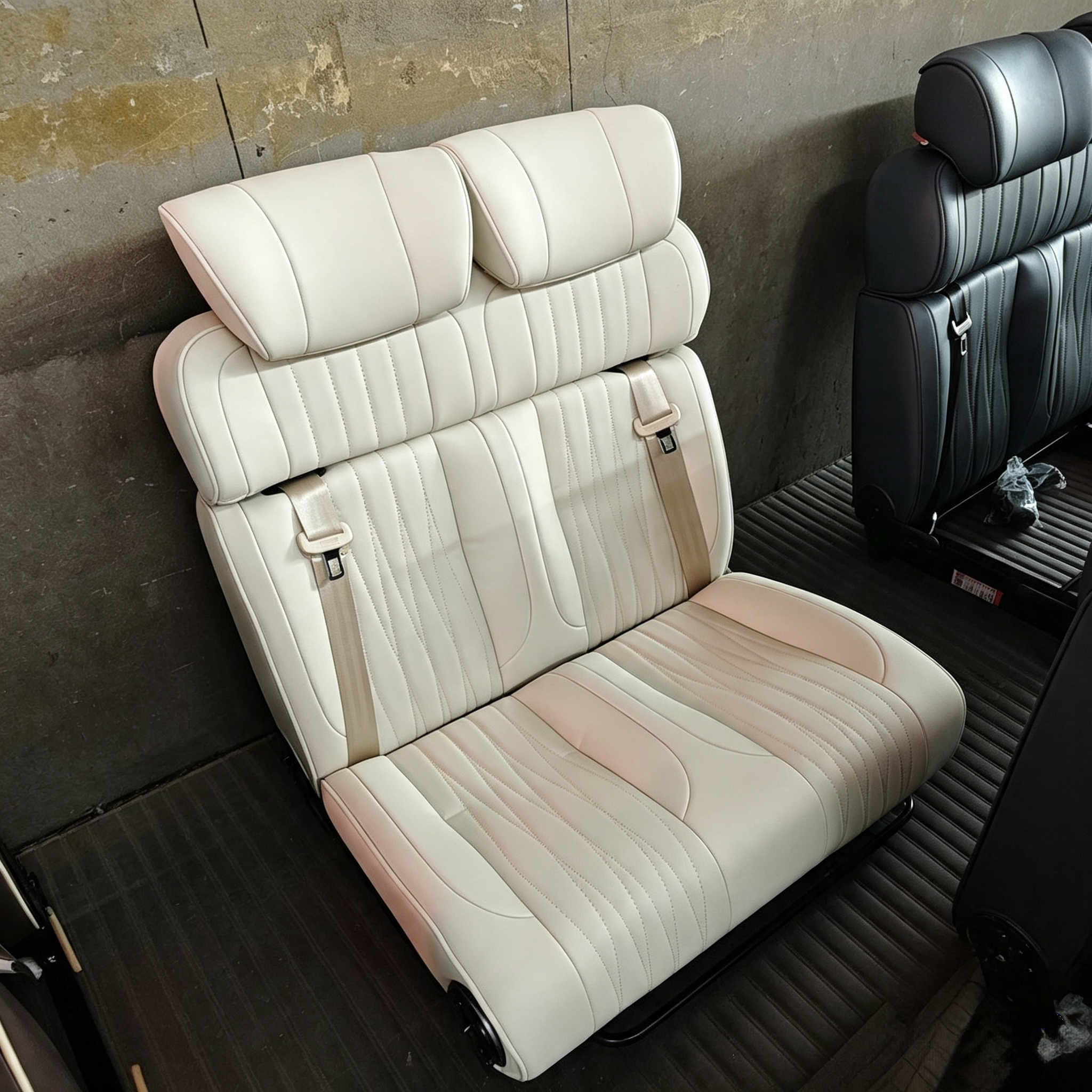 Close-up view of beige luxury leather RV seat bed with vertical pleated stitching