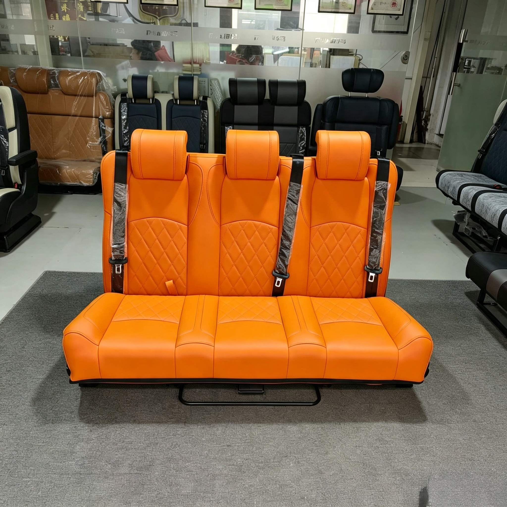Bright orange diamond stitched 3-passenger camper van seat bed