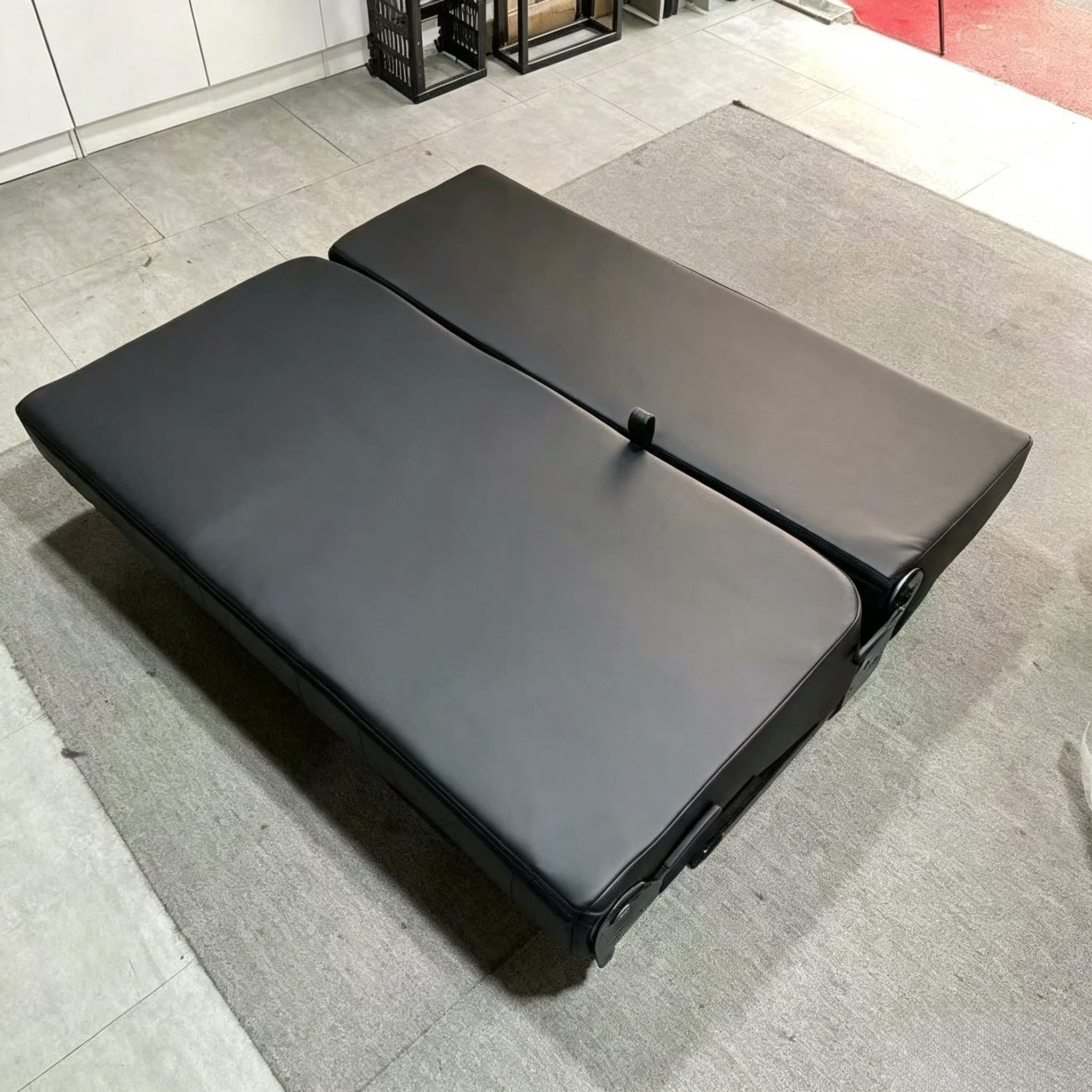 Three-seater camper van seat bed completely folded flat into a sleeping mattress