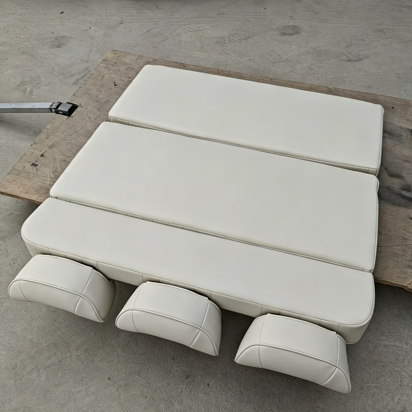 Beige camper van seat bed completely folded flat into a sleeping mattress platform