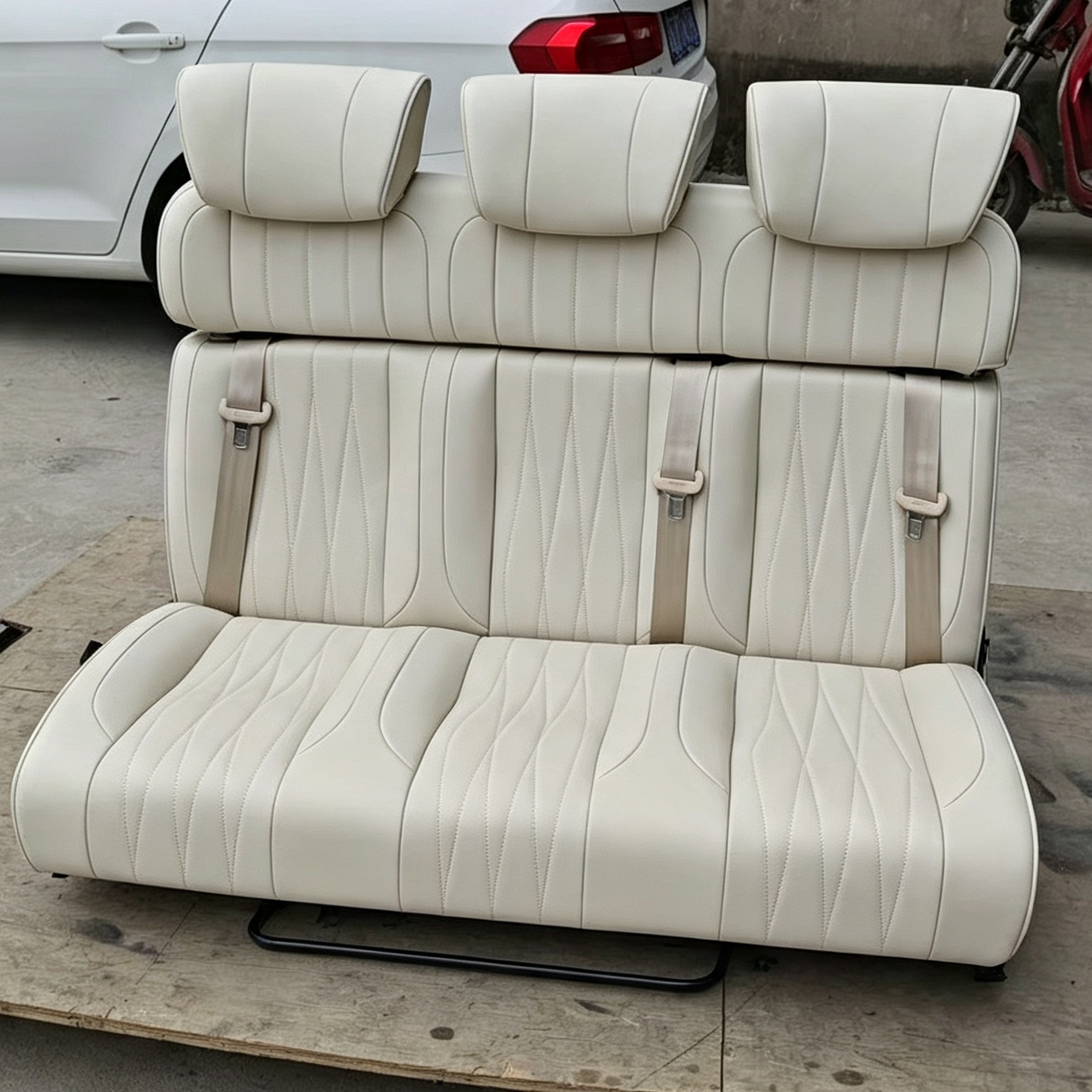 Off-white 3-seater RV bench seat bed with 3 headrests and integrated safety belts