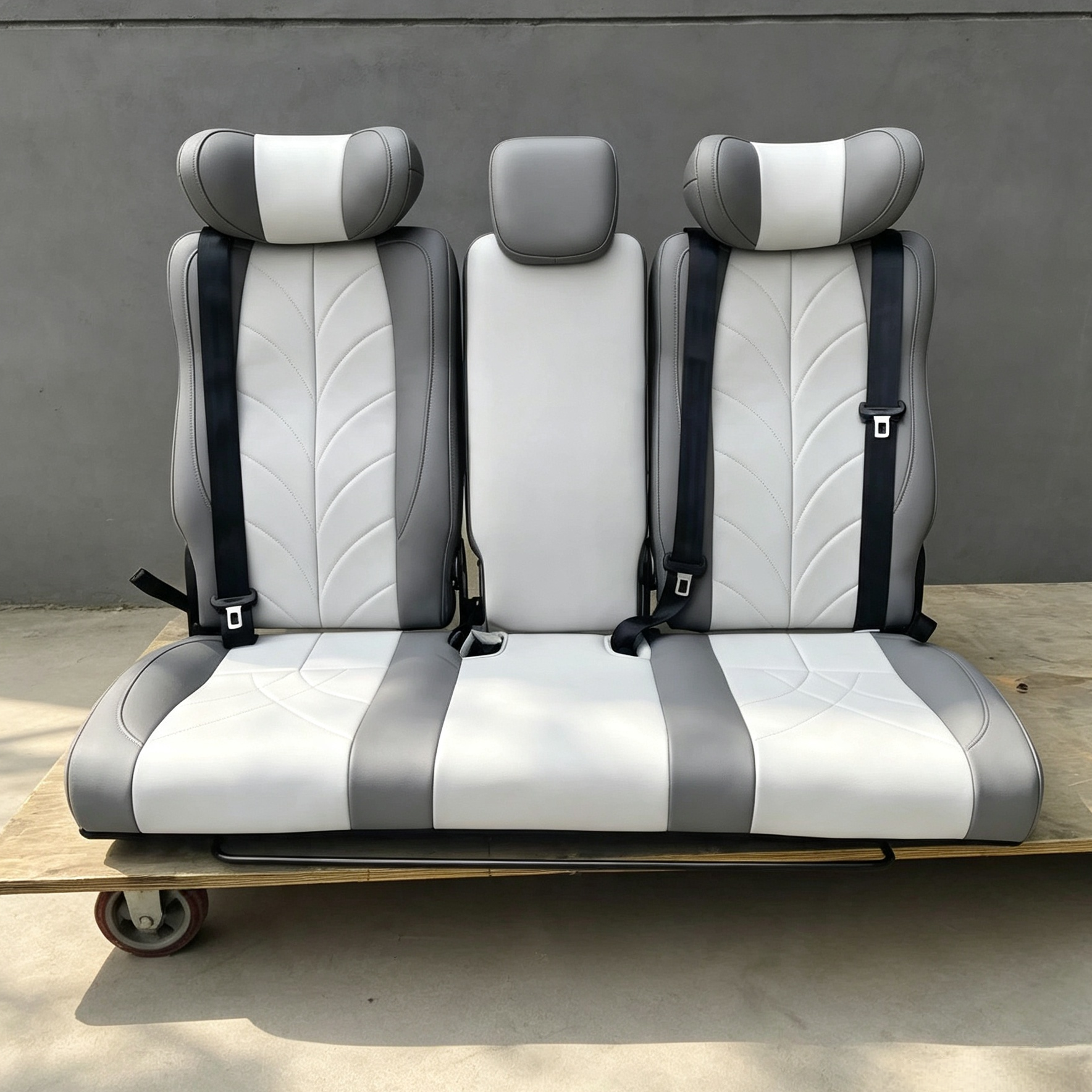 Front view of two-tone gray and white 3-seater RV bench seat bed with 3 headrests